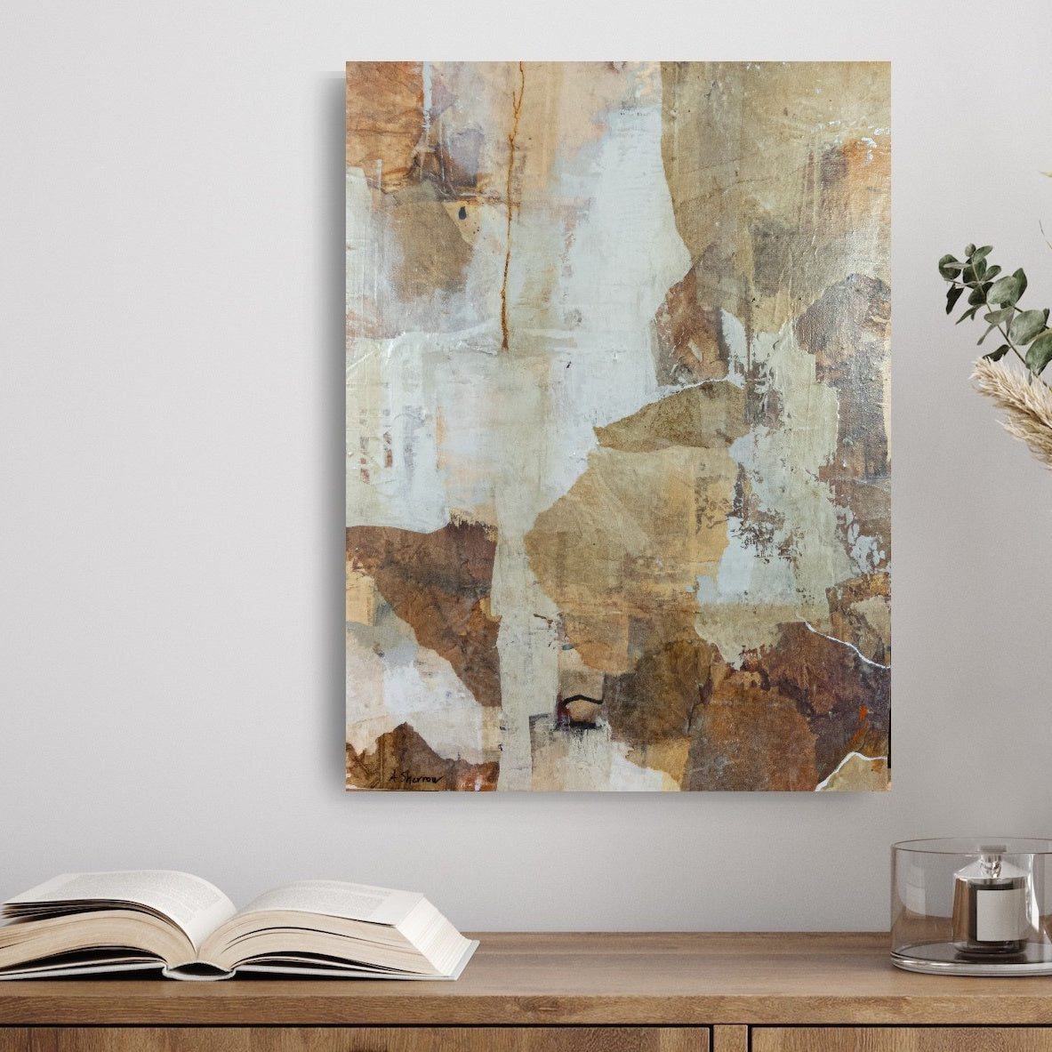 Abstract mixed media painting Woodland Falls hanging on an office wall. The artwork features textured layers of earthy browns, warm sienna, soft creams, and muted whites, adding a touch of nature-inspired tranquility to the workspace.