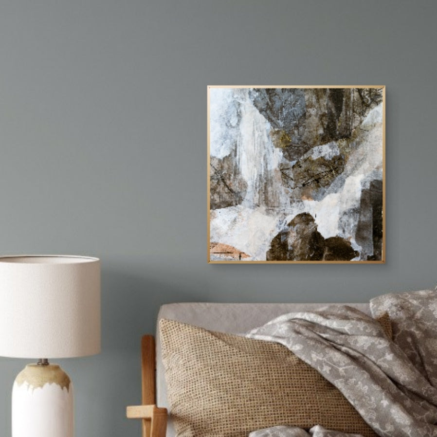 "A Chill in the Air" hanging on a dark accent wall above a warm-toned couch, styled with textured pillows and a lamp, showcasing its versatility in modern home decor.