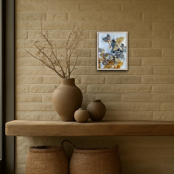 Decorative setup with vases and a nature painting in warm earth colors on a brick wall.