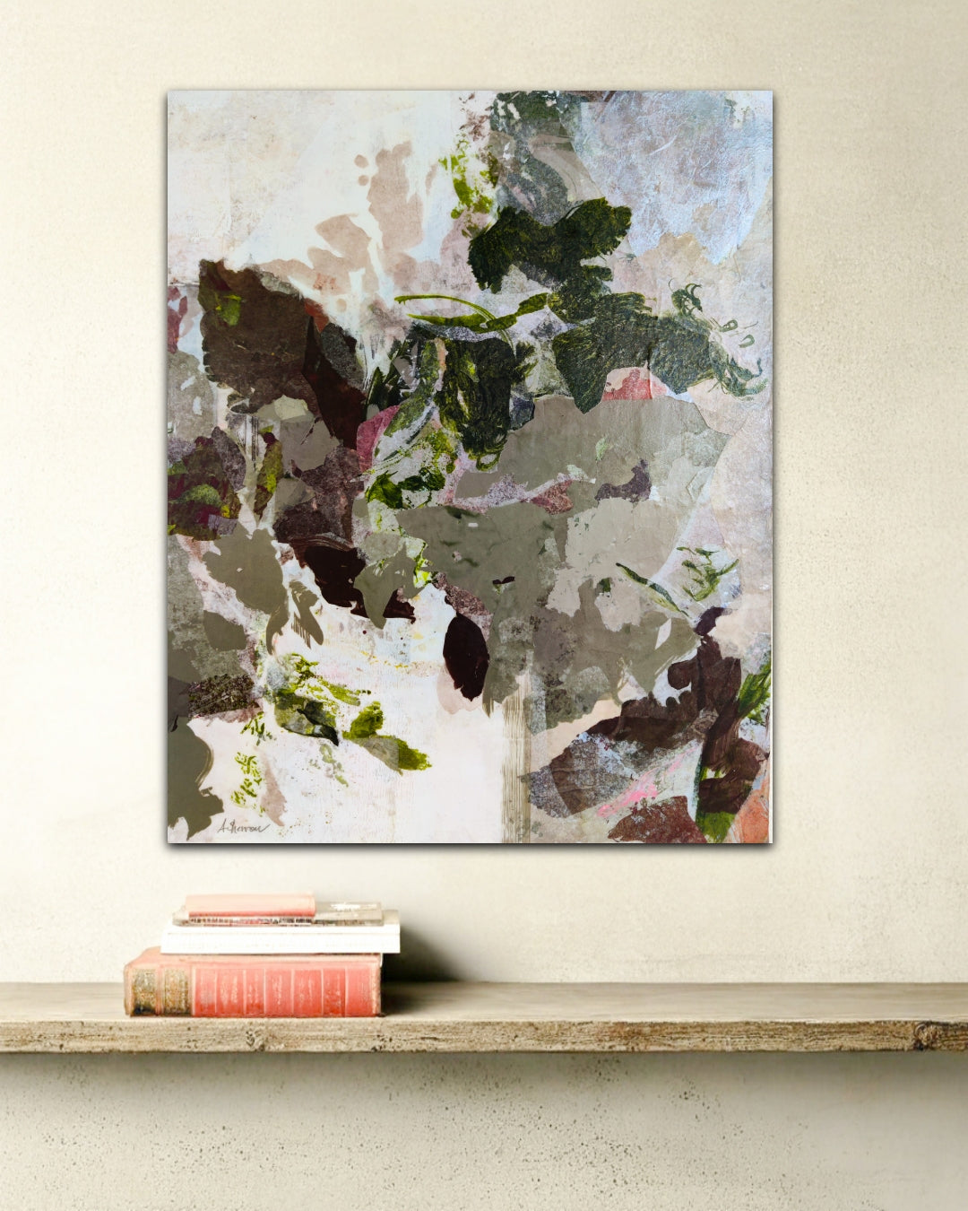 Abstract art painting on a wall above books