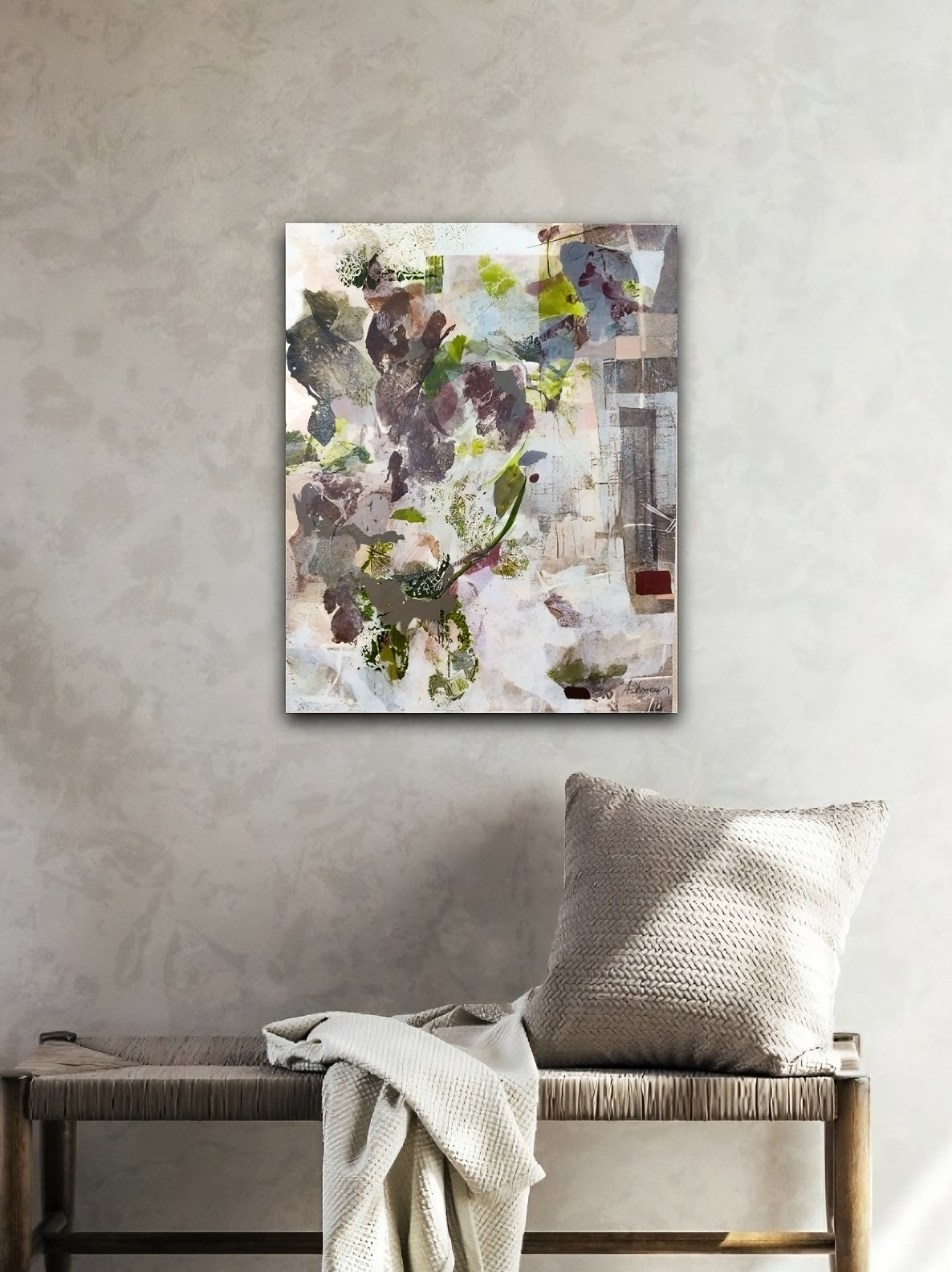 Abstract painting on a wall above a bench with a pillow