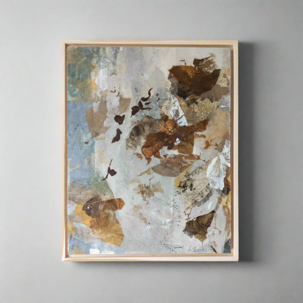 Abstract art piece with brown, white, and blue colors in a wooden frame on a gray wall.